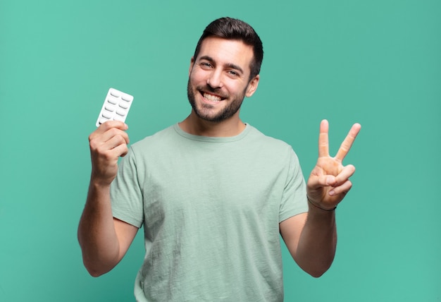 Young handsome man with a pills tablet. illness or ache concept