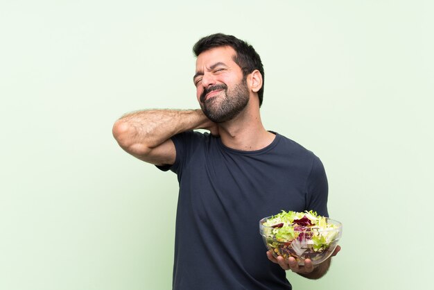 Young handsome man with salad with neckache