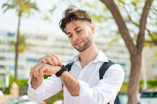 Young handsome man with sport watch