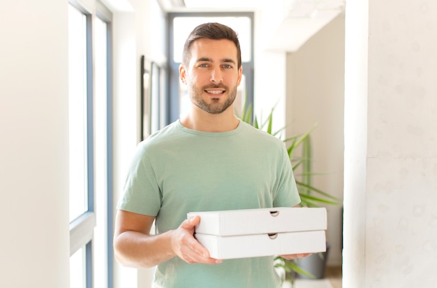 Young handsome man with take away pizza boxes at home