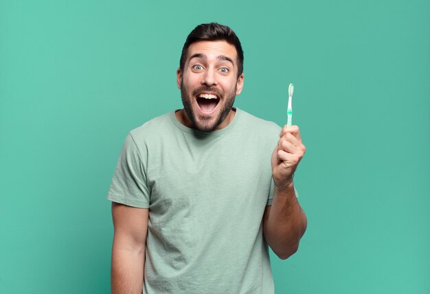 Young handsome man with a teethbrush.