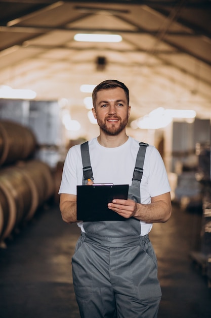 Young handsome man working at a factory