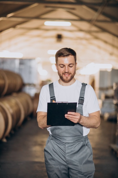 Young handsome man working at a factory