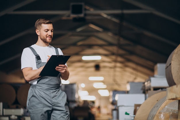 Young handsome man working at a factory