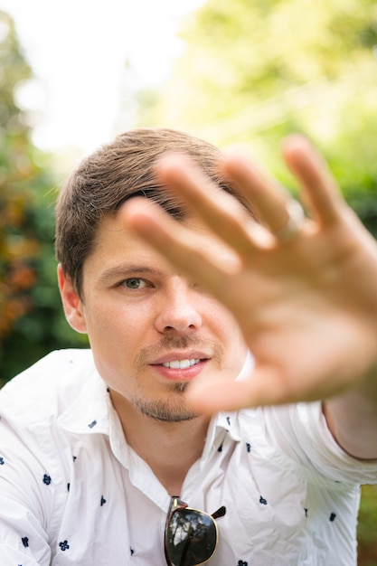 Young handsome married man is touching the monitor 