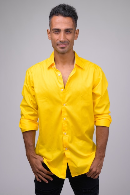 Young handsome Persian businessman with yellow shirt