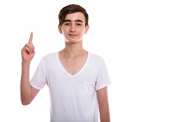 young handsome Persian teenage boy pointing finger