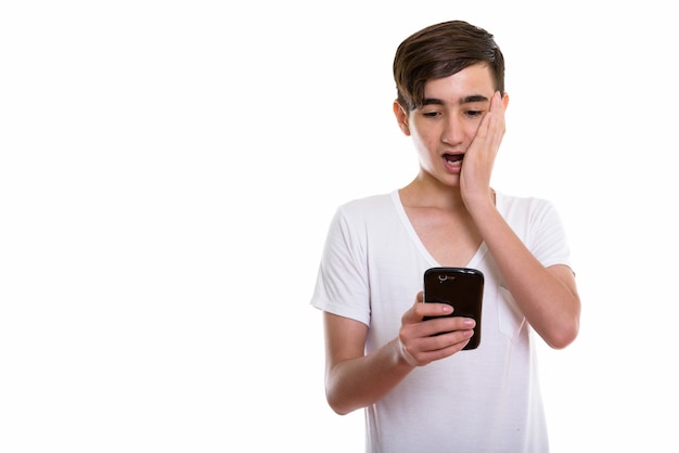 young handsome Persian teenage boy using mobile phone