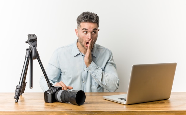 Young handsome photography teacher is saying a secret hot braking news and looking aside