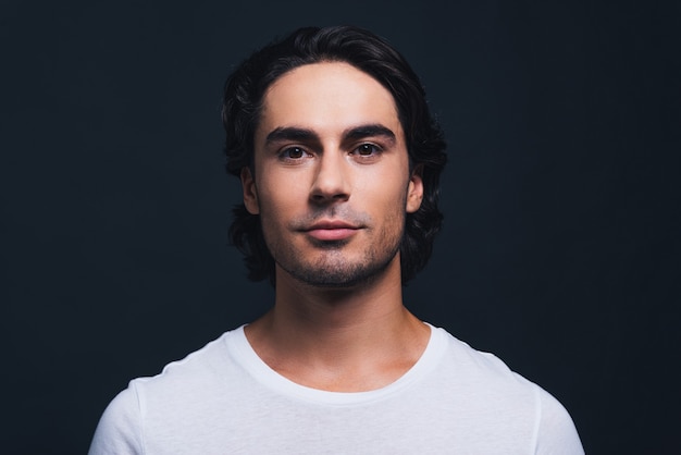 Young and handsome. Portrait of handsome young man looking at camera while standing 