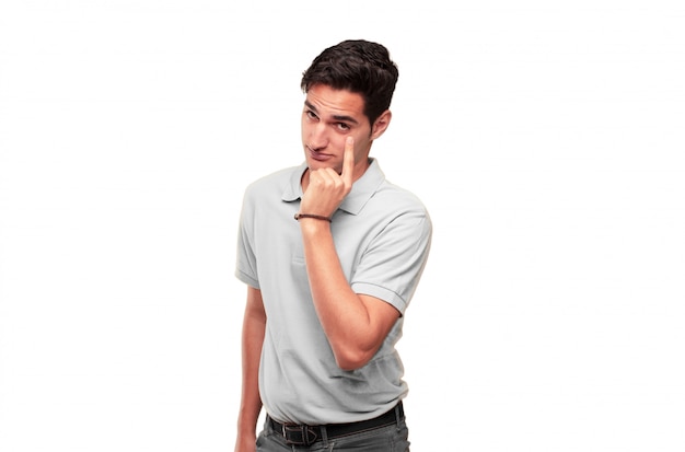 Young handsome tanned man looking, observing, keeping an eye on an object in front, or watching out 