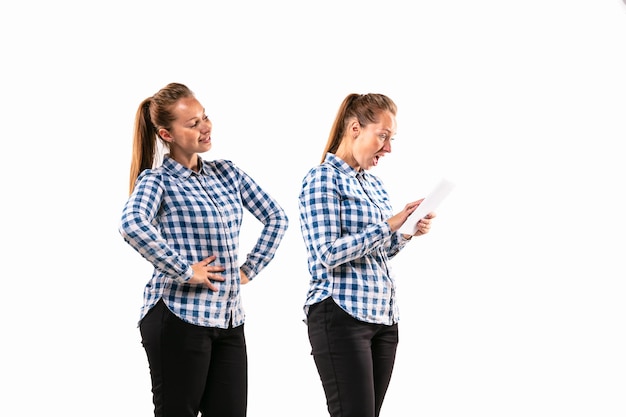 Young handsome woman arguing with herself on white studio background.