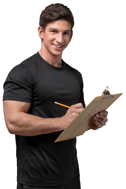 Young handy man with clipboard on background