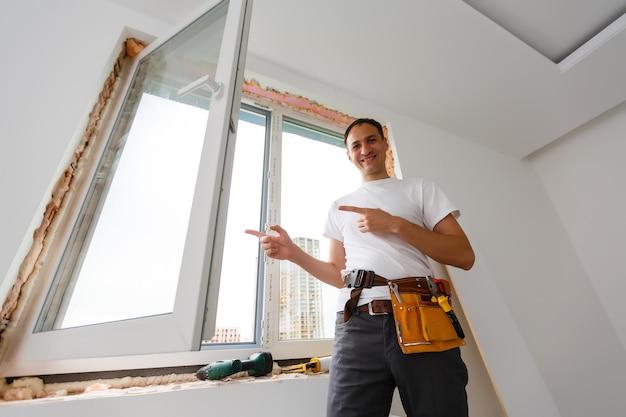 Young handyman repair window with screwdriver