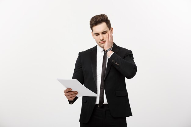 Young hansome businessman with a document in his hands isolated over white background.