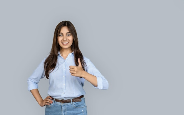 Young happy adult indian woman showing thumb up