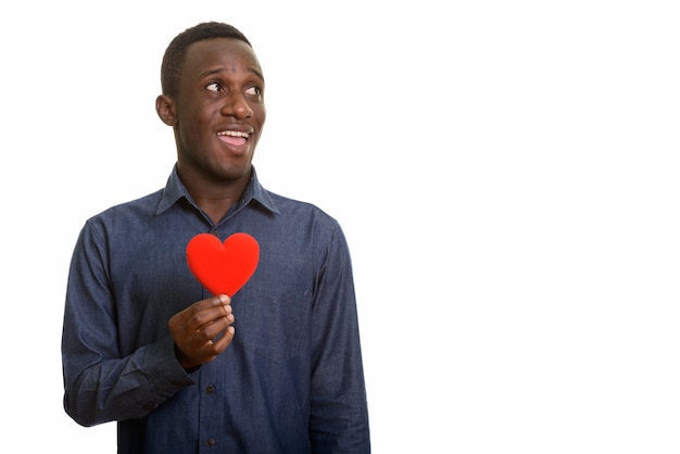 Young happy African man smiling with red heart on chest