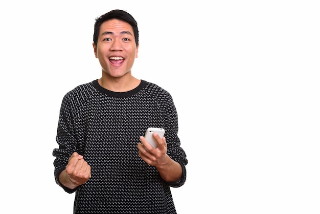  young happy Asian man smiling while holding phone
