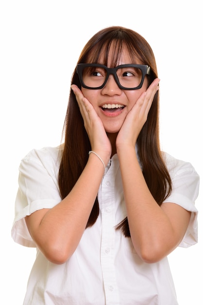 Young happy Asian teenage girl smiling looking surprised