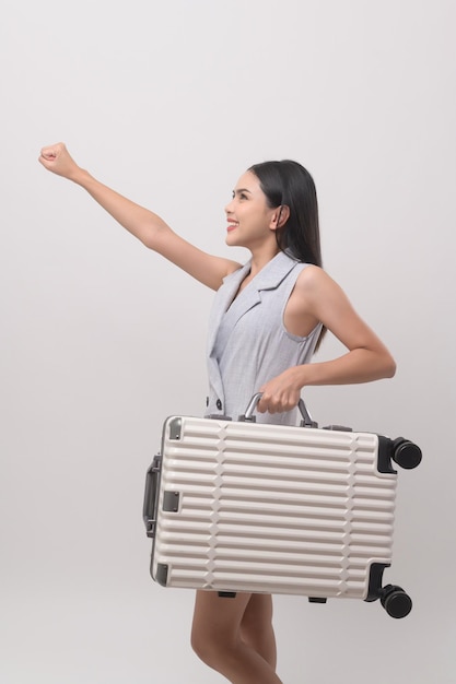 Young happy asian tourist woman over white background studio travel and holidays concept