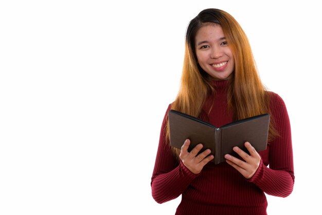 young happy Asian woman reading book