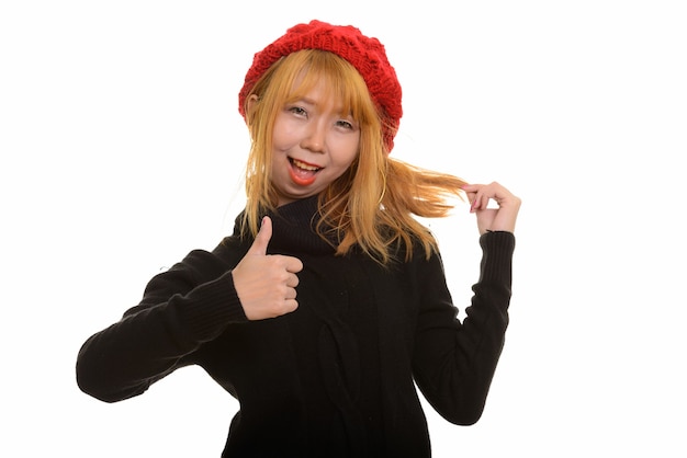 Young happy Asian woman smiling and giving thumb up