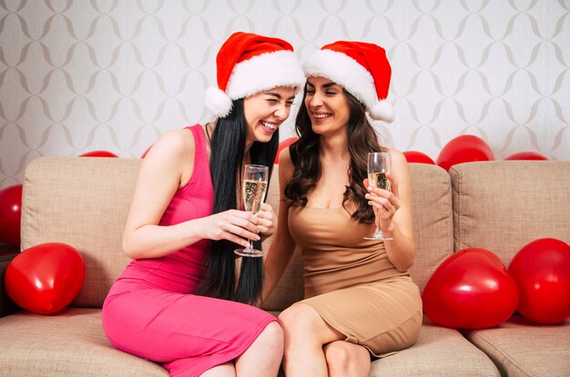 Young happy beautiful women in santa hats