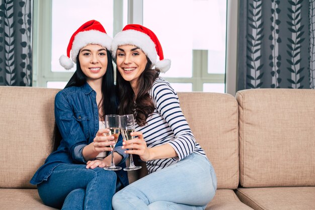 Young happy beautiful women in Santa hats