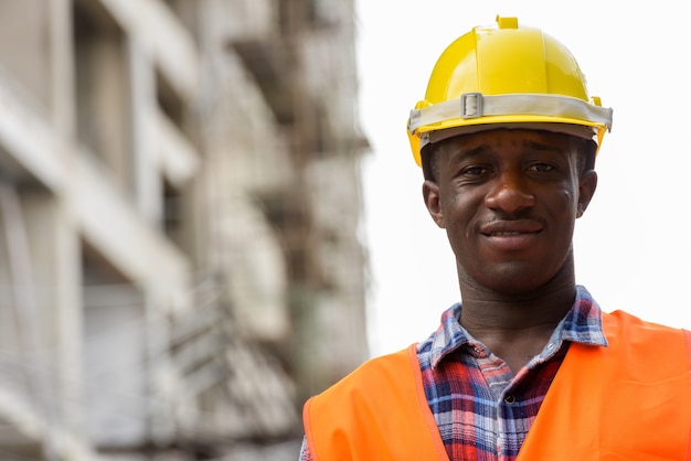 Young happy black African man construction worker smiling