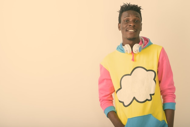 young happy black African man smiling while wearing headphones around neck