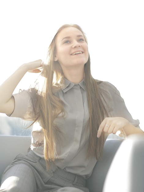 Young happy business woman sitting in office chair