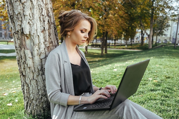 Young happy business woman with laptop