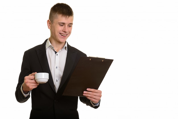 young happy businessman smiling and reading on clipboard