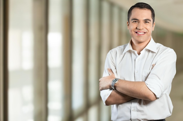 Young happy businessman in white shirt