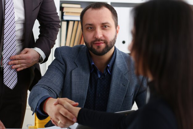 young happy businessmen have meeting in office shake hands with each other