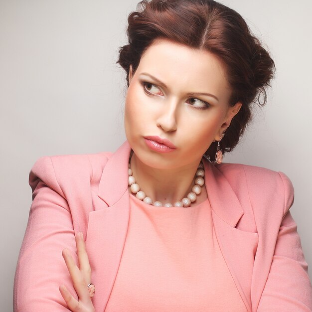 Young happy businesswoman in pink