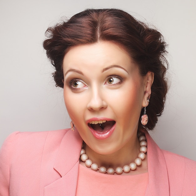 Young happy businesswoman in pink