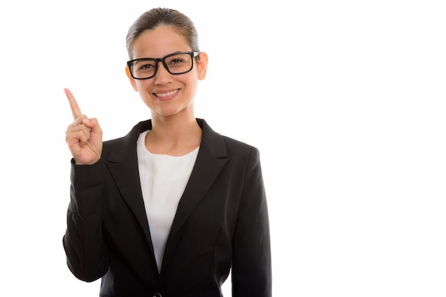 young happy businesswoman smiling while pointing up