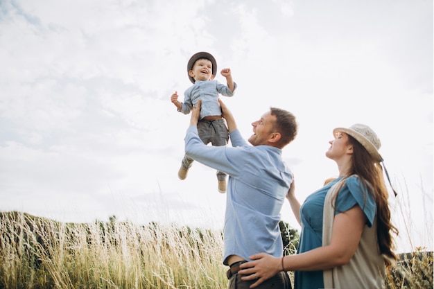 Young happy caucasian couple with baby boy. Parents and son having fun together.