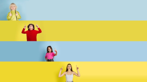 Young happy caucasian kids gesturing isolated on multicolored studio background. Human emotions