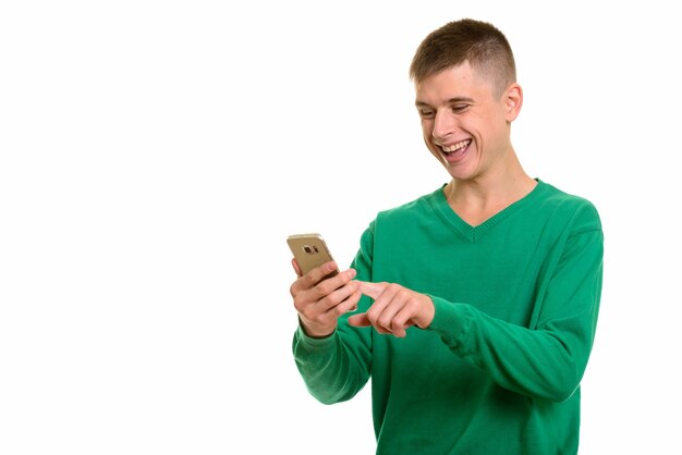 Young happy Caucasian man smiling and using mobile phone