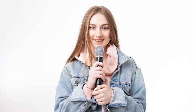 Young happy caucasian woman holding microphone isolated on white background