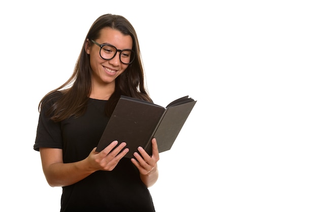 Young happy Caucasian woman smiling and reading book isolated on white