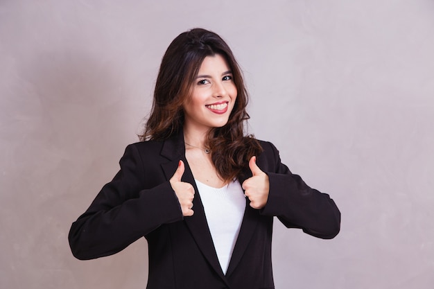 Young happy cheerful woman showing thumb up