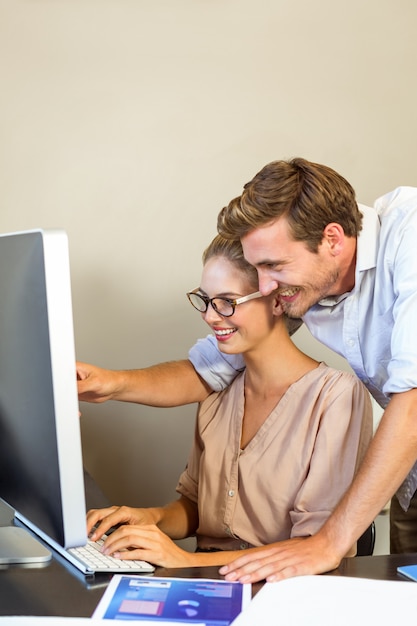 Young happy colleagues working at office