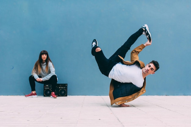 Young happy couple dancing on the street with a vintage radio cassette stereo xA