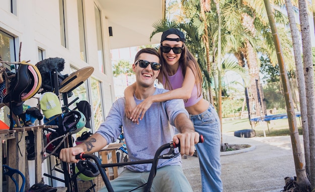 Young happy couple enjoy bmx riding at the skatepark