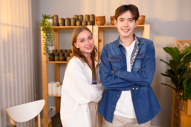 A young happy couple entrepreneur smiling in them craft products shop