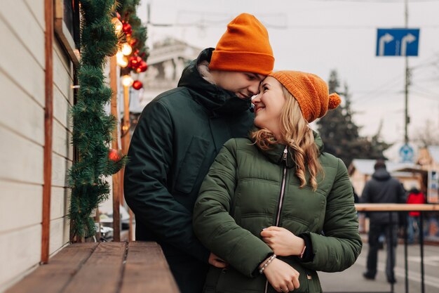 Young happy couple having fun together at a Christmas market