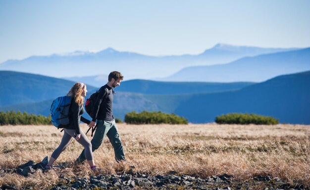 Young happy couple hiking in the beautiful mountains